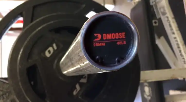 End cap of a DMoose Regional Barbell shows diameter and weight of barbell