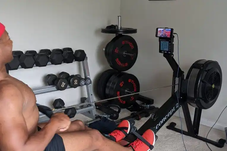 A BBR team member is testing on the Concept2 rower indoor machine to test functionality.