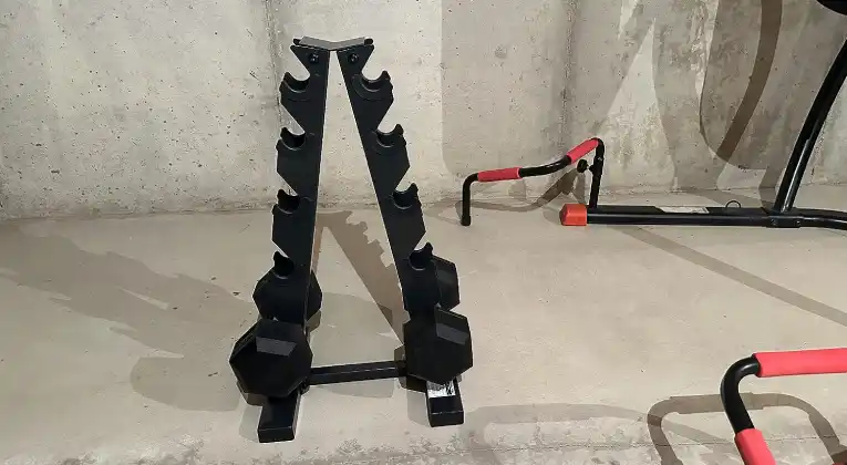 a  CAP Barbell 150lbs Dumbbell dumbbell rack with dumbbells on a concrete floor