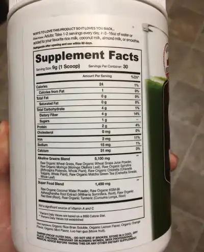 a jar of green powder with a label listing its ingredients and nutritional information.